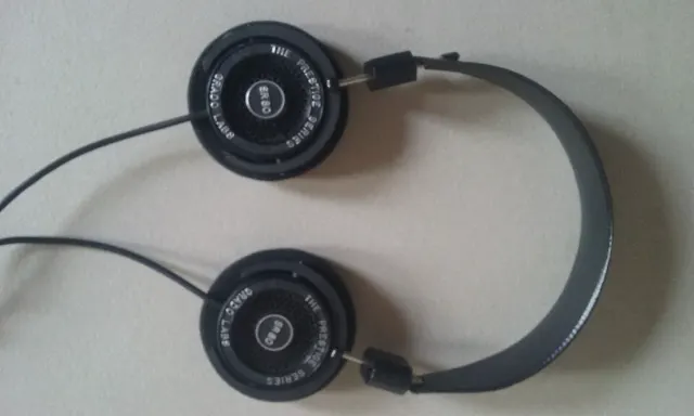 Grado SR80 Prestige series headphones lying flat, round open earcups with metal grilles
